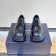 Prada Men's Brushed Leather Derby Shoes in black front view Front view of black Prada Men's Brushed Leather Derby Shoes showing rounded toes and lace-up fastening