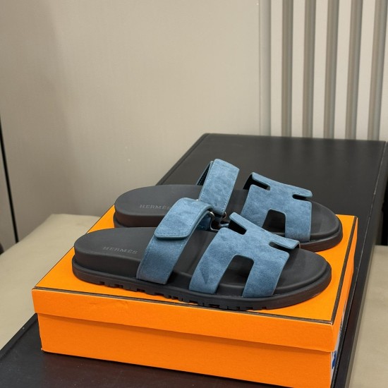 Hermes Chypre Blue Suede Sandals Angled Presentation Angled view of the blue suede sandals positioned together on top of their presentation box