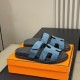 Hermes Chypre Blue Suede Sandals Angled Presentation Angled view of the blue suede sandals positioned together on top of their presentation box
