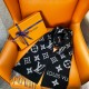 L Women's Monogram Black And White Scarf Close-Up L Women's Monogram Black And White Scarf styled with loops and fringed detail