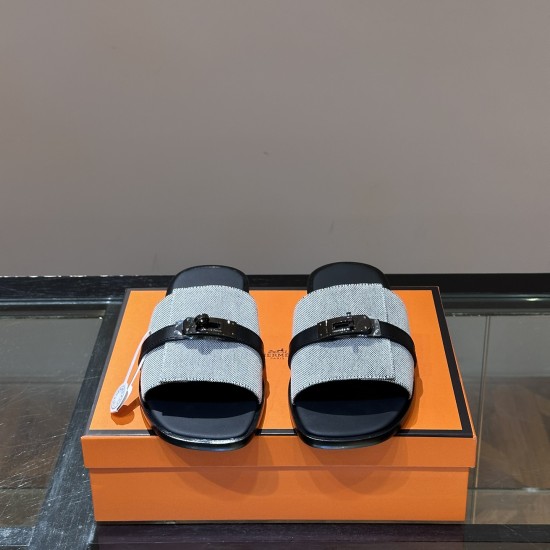 Frontal view of Hermes Gabriel grey and black sandals highlighting upper straps and hardware