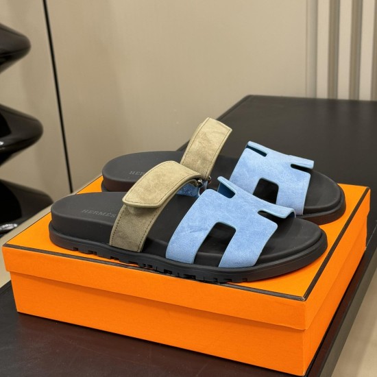 Hermes Chypre Sandals in blue and khaki angled display Angled perspective of Hermes Chypre Sandals in blue and khaki positioned on a presentation box