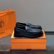 Hermes Men's Guillaume Black Loafers Angle View Three-quarter side angle of Hermes Men's Guillaume Textured Leather Loafers In Black displayed on box