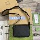 Gucci men's black rubber-effect mini shoulder bag angled presentation Gucci men's black rubber-effect mini shoulder bag top-down angled view displaying adjustable strap and box presentation