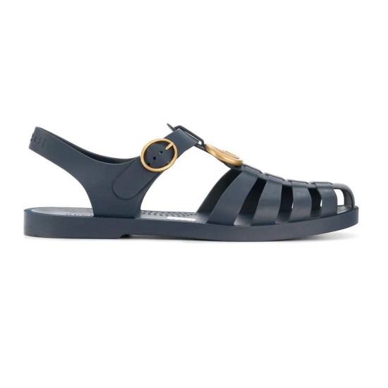 Gucci Blue Rubber Sandals Outer Lateral View in blue and white Gucci rubber buckle strap sandals in blue shown from the outer lateral side against a white background