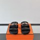 Front View of Hermes Jackson Sandals in Black and Brown Front facing view of Hermes Jackson Sandals in black and brown displaying the dual strap layout