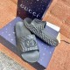 Gucci black slide sandals packaging and angled view Gucci black slide sandals displayed on patterned luxury packaging boxes