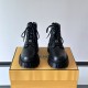 Front view of black Fendi Men's FF Jacquard And Leather Biker Boots Front view of black Fendi Men's FF Jacquard And Leather Biker Boots highlighting the lace-up closure and rounded toes