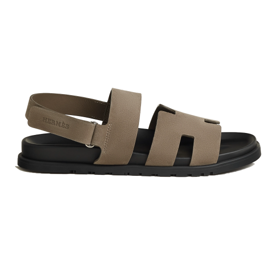 Hermes Etoupe Suede Flat Sandal Lateral Profile View in black Hermes etoupe suede flat sandal showing lateral profile view with black sole