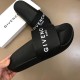 Givenchy Black Pool Slides With Box in black and white Handheld angle view of Givenchy black pool slides next to their branded presentation box in black and white