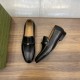 Gucci Men's Interlocking G Leather Loafers Black Pair Display Gucci Men's Interlocking G Leather Loafers Black pair on wood background