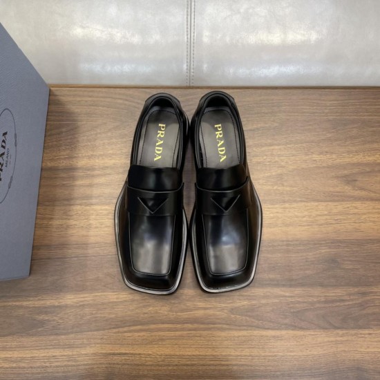 Prada Men's Brushed Leather Loafers In Black Front Pair View Prada men's black brushed leather loafers positioned side by side from the front