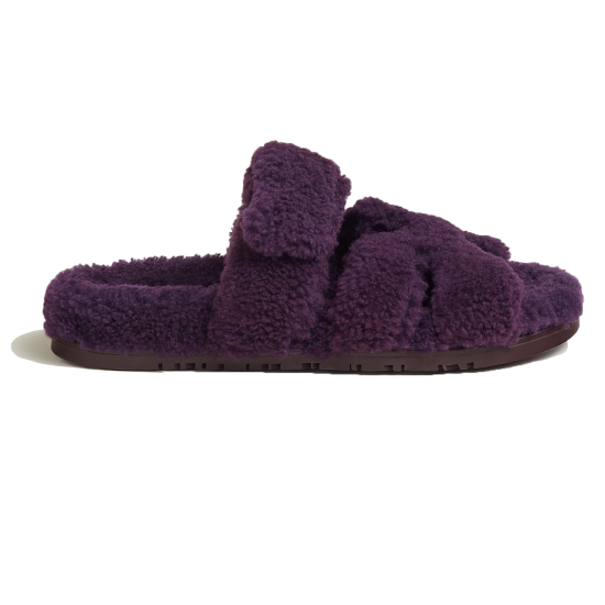Side profile of Hermes Chypre slide sandals in violet shearling