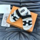 Hermes Chypre Sandals angled view resting on an orange box with dust bag in ecru and black