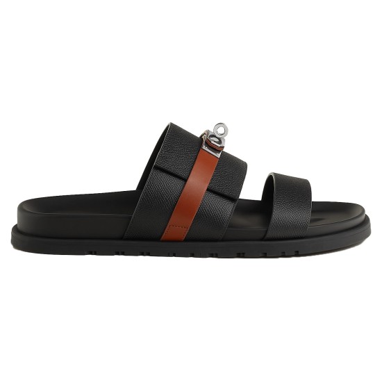 Side Profile View of Hermes Jackson Sandals in Black and Brown Side profile of Hermes Jackson Sandals in black and brown showing the textured strap and metallic buckle