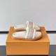 Angled view on orange box of white ecru L mules Angled view of the white ecru L mules resting on a signature orange presentation box