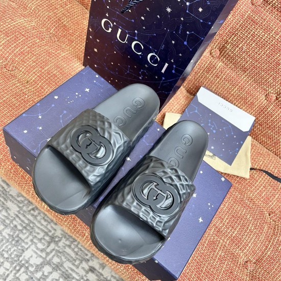 Gucci black slide sandals top down view Gucci black slide sandals viewed from above highlighting the footbed branding