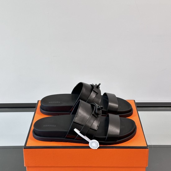 Hermes Jackson Sandals In Black on Box Hermes Jackson Sandals In Black resting on an orange box from an angled view