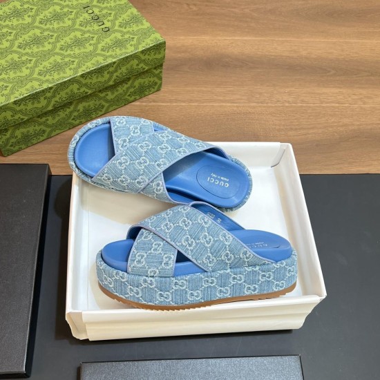 Angled view of Gucci blue denim platform slide sandals Angled pair of Gucci blue denim platform slide sandals displayed together