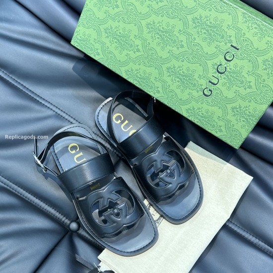 Gucci Black Leather Sandals Angled Overview Angled overhead view of Gucci black leather sandals highlighting the front interlocking details