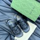 Gucci Black Leather Sandals Angled Overview Angled overhead view of Gucci black leather sandals highlighting the front interlocking details