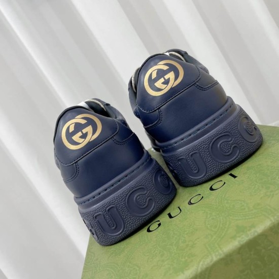 Gucci Dark Blue Trainers Heel Detail Rear view showing gold GG emblems on heel tabs and embossed sole logo in dark blue