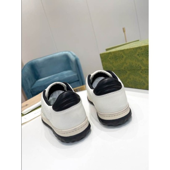Gucci Mac80 Rear Heel View in off-white and black Rear view showing black leather heel tabs and textured soles of both trainers in off-white and black