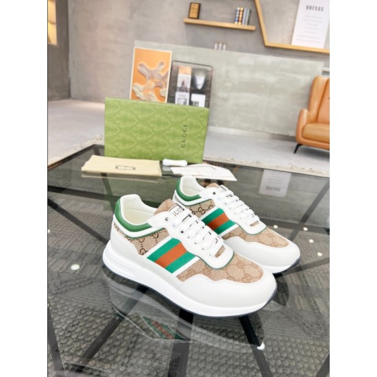 Three-quarter view of Gucci white leather and beige GG canvas trainers resting on glass table