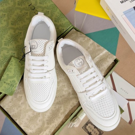 Gucci Trainers Overhead View in white and gold Overhead view of white Gucci trainers highlighting perforated tongue and vamp details in white and gold