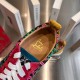 Detail view of the branded tan leather interior footbed and collar of the multicolour trainers in multicolour and red