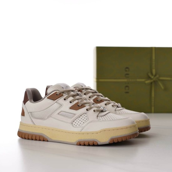Pair of Gucci white and brown low top trainers positioned at a three-quarter angle