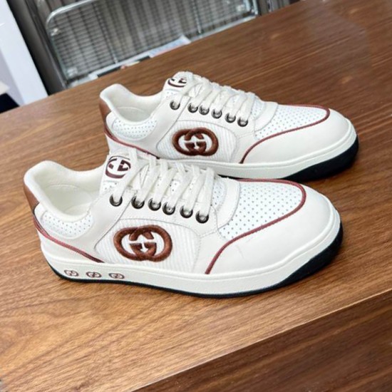 Side profile of Gucci white and brown leather logo trainers on display