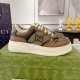 Gucci Brown Monogram Low-Top Trainer Side View in brown and green Side profile view of Gucci brown monogram canvas low-top trainer on green box