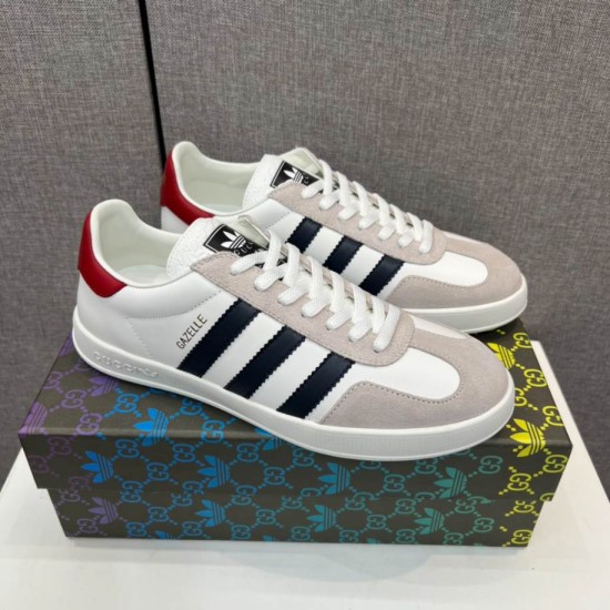 Gucci Gazelle White Trainers on Box in white and black Three-quarter view of Gucci Gazelle white trainers resting on branded box in white and black