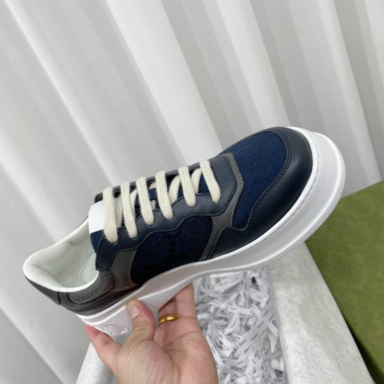 Close-up hand-held view of the Gucci grey blue chunky trainer showing its thick white platform sole