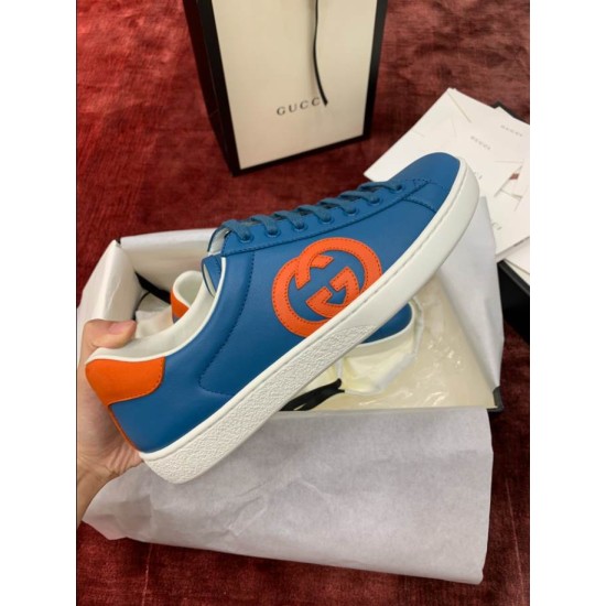 Blue Leather Trainer Profile Detail in blue and orange Close-up profile view of blue leather trainer displaying orange logo patch and sole texturing
