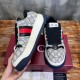 Gucci Screener Web Trainers Handheld Angle in beige and blue Handheld side and front angle of Gucci Screener Web Monogram Canvas Trainers in beige blue