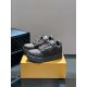 L Maxi Monogram Canvas Low Top Trainers in ebony brown angled layout Front three-quarter view of L Maxi Monogram Canvas Low Top Trainers in ebony brown on a box