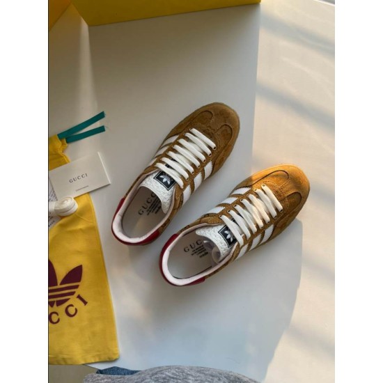 Gucci Gazelle Yellow Canvas Trainers Overhead Pair in yellow and white Overhead perspective of both yellow canvas Gucci Gazelle low top trainers displayed on a light surface in yellow and white