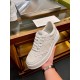Handheld front-facing angle of Gucci white low-top trainer highlighting toe cap and lacing