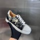 Christian Louboutin Spiked Low Top Trainer Handheld View in black and white Hand holding a single Christian Louboutin black and white graphic trainer with spiked toe