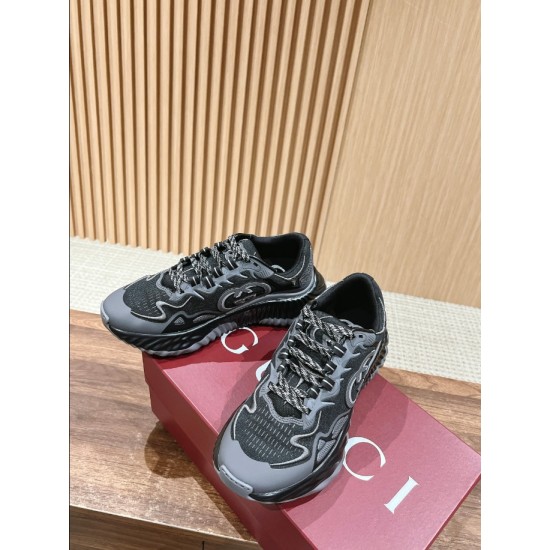 Gucci Ripple Trainers Box Display in black and grey Pair of black and grey Gucci trainers positioned on a red shoe box