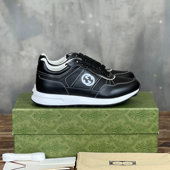 Gucci black leather low top trainers with white soles side profile view