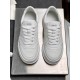 Top-down pair view of Gucci white embossed trainers showing lace closure and tongue branding