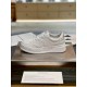 Side elevation of single Gucci white embossed leather trainer displayed on a metal platform