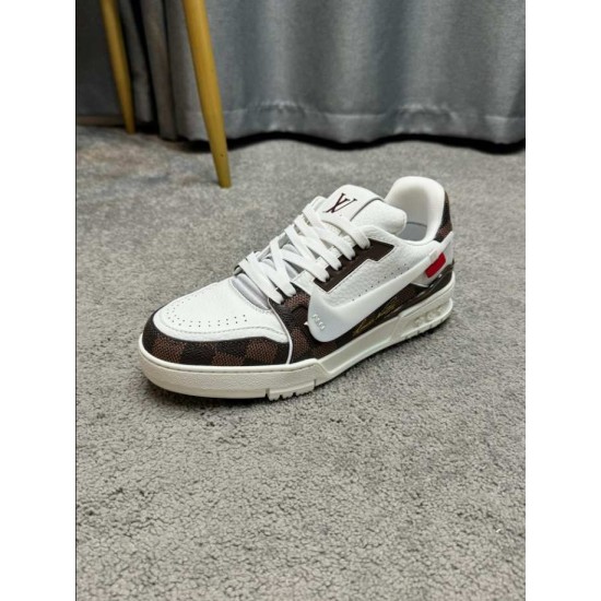 L Trainer Damier Leather White Brown Low Top Trainers Three-Quarter Angle Angled view of L Trainer Damier leather white brown low top trainer resting on carpeted surface