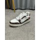 L Trainer Damier Leather White Brown Low Top Trainers Three-Quarter Angle Angled view of L Trainer Damier leather white brown low top trainer resting on carpeted surface