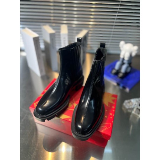 Christian Louboutin Men's Black Leather Chelsea Boots Front Pair View Front perspective view of both Christian Louboutin Men's Black Leather Lug Sole Chelsea Boots highlighting front seams and soles.