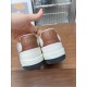Close-up view of brown leather heel tabs with gold Gucci lettering in white and brown