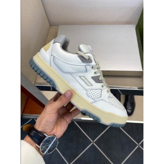 Gucci Trainer Lateral Side and Midsole View in white and grey Hand holding Gucci trainer showing outer side panel and yellowed rubber sole detail in white and grey